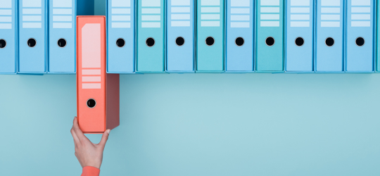 Office worker taking an highlighted folder in the archive