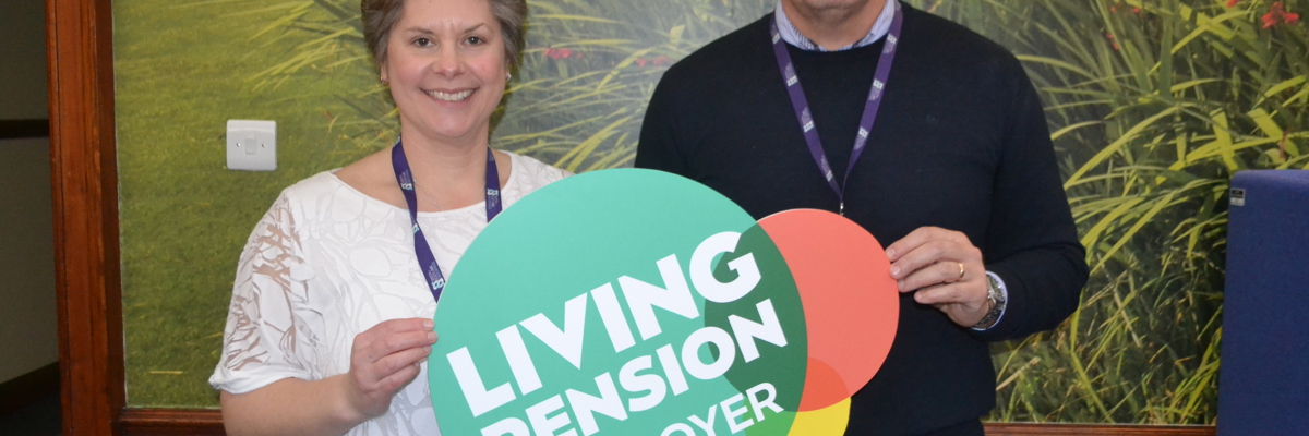 Staff support Living Pension holding sign